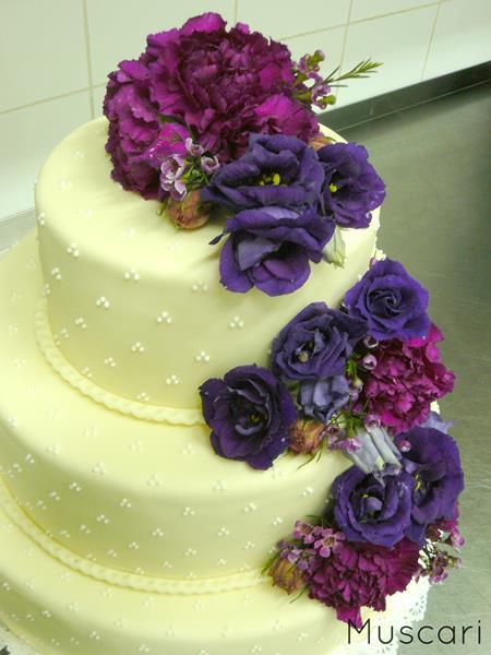 tort weselny z eustomami, wax flower i goździki w fioletowych odcieniach