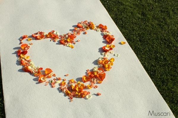 płatki kwiatów w kształcie serca na białym dywanie w ogrodzie