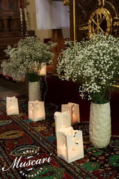 gipsówka w wazonach i lampiony ze świecami w dekoracji kościoła