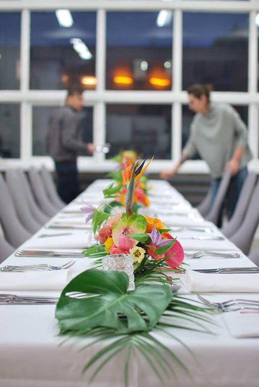 egzotyczne kwiaty i liście w dekoracji stołu na dzień kobiet
